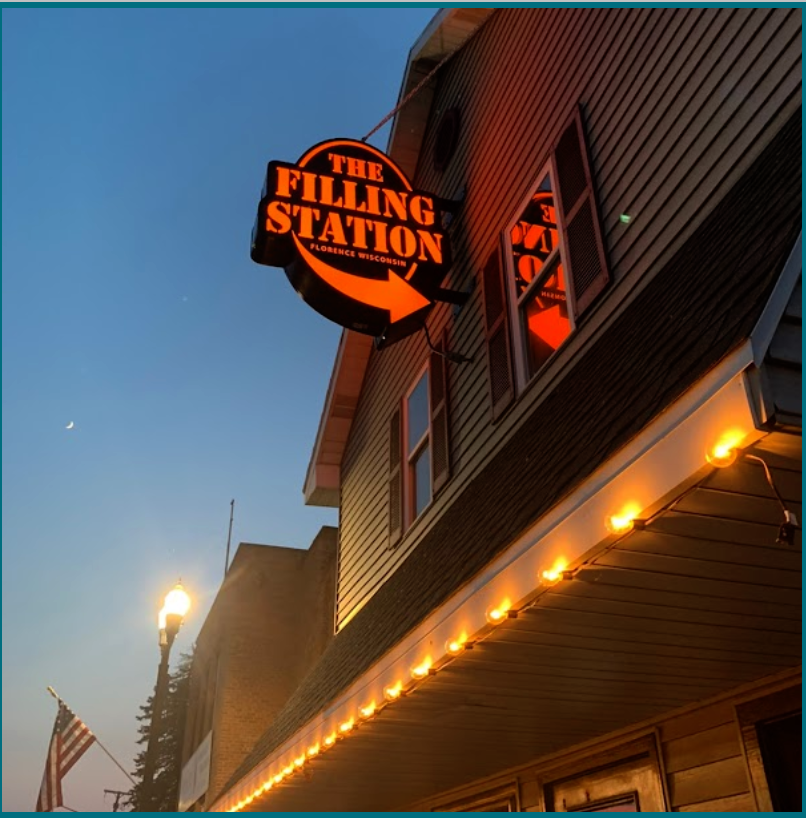 The sign at dusk on Central Ave